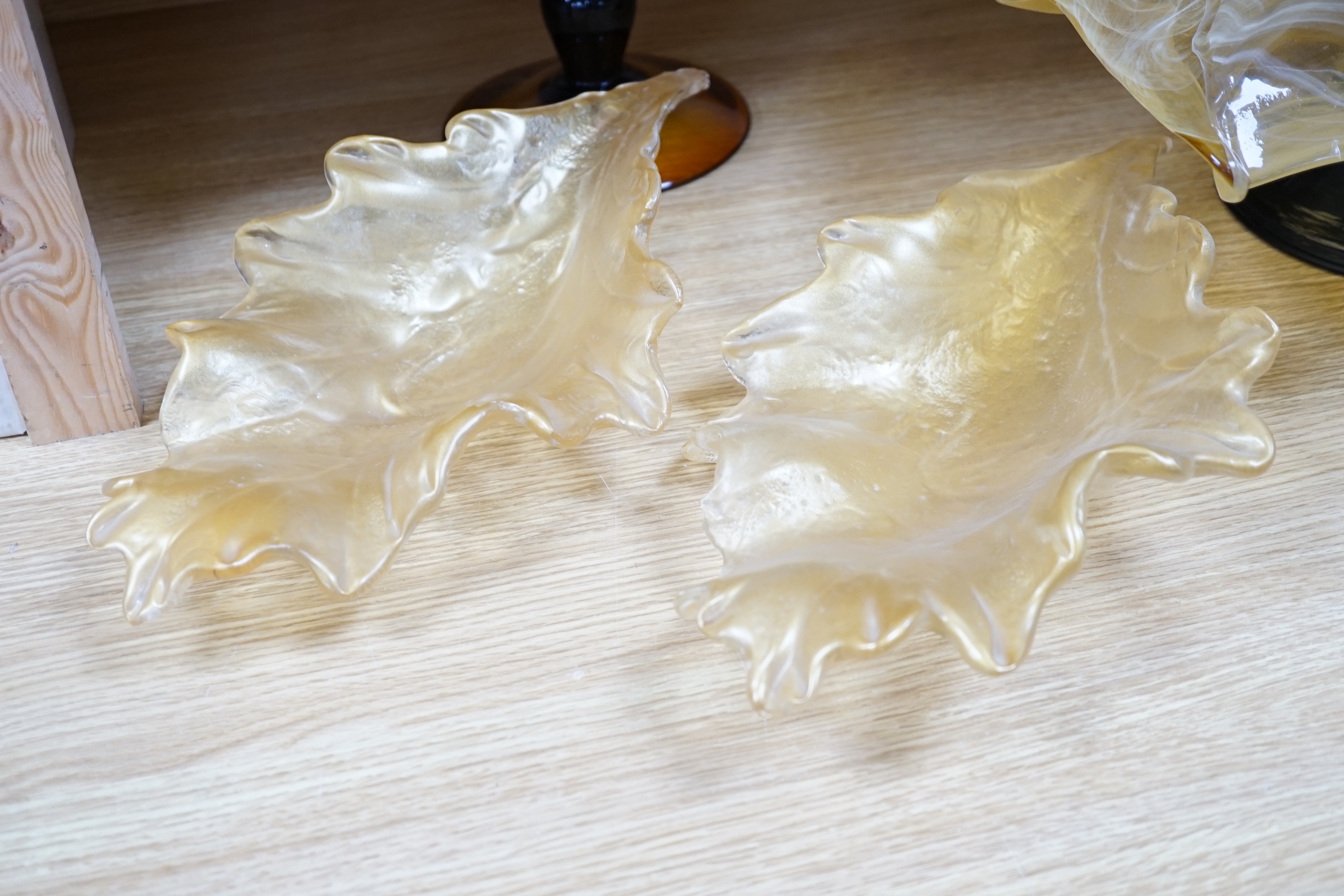 Two amber glass frilled table centrepieces, one with Murano label to the base and a pair of similar leaf shaped dishes (4), the largest 48cm wide